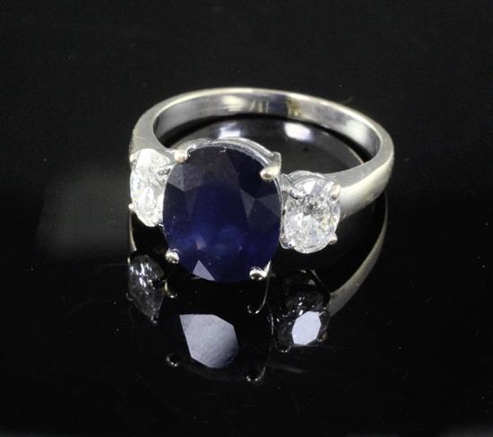 An 18ct white gold sapphire and diamond three stone dress ring, size O/P.